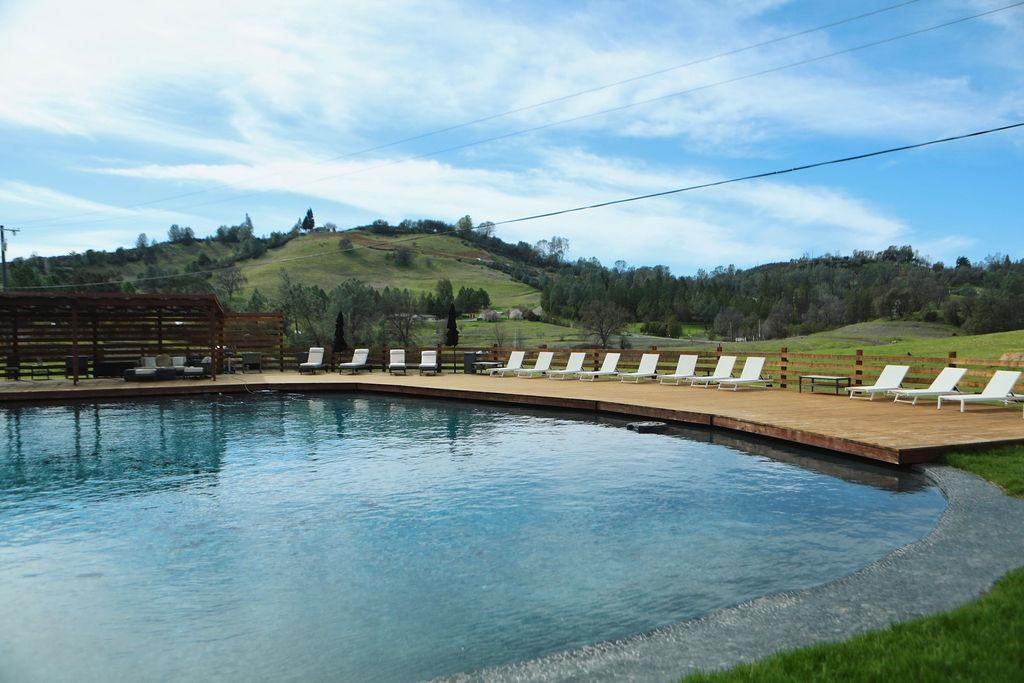 Large pool with lounge deck and rolling hills